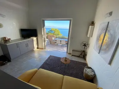a living room with a couch and a view of the ocean at Villa Tarco, South Corsica, Sea View & Garden in Conca