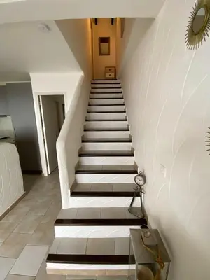 a staircase in a house with white and gray stairs at Villa Tarco, South Corsica, Sea View & Garden in Conca