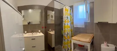a living room with a couch and a table at Appartement T2 50 m2 Ricanto à AJACCIO in Ajaccio