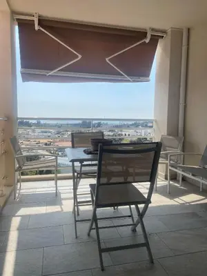 a bed with a comforter and pillows on it at Appartement T2 50 m2 Ricanto à AJACCIO in Ajaccio