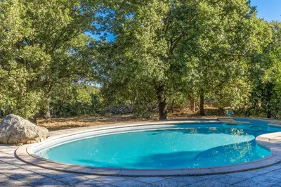 an empty swimming pool with trees in the background at Casa U Quercitellu Ville-di-Paraso in Ville-di-Paraso