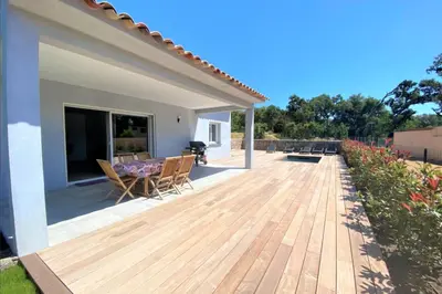 a wooden deck with a table and chairs on a house at Villa Oliu Di Santa Lucia in Conca