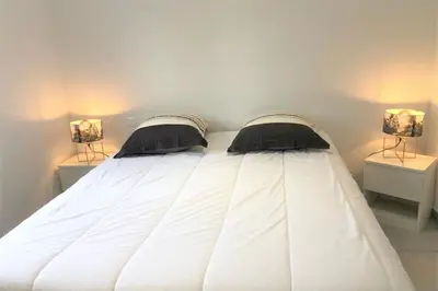 a white bed with two pillows on top of it at Villa Oliu Di Santa Lucia in Conca