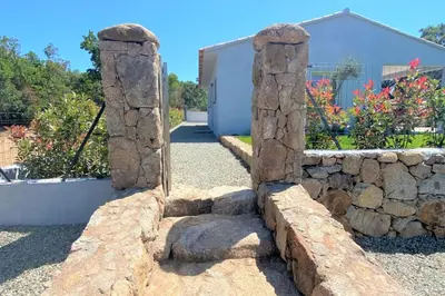 a stone retaining wall with two stone arch doors at Villa Oliu Di Santa Lucia in Conca