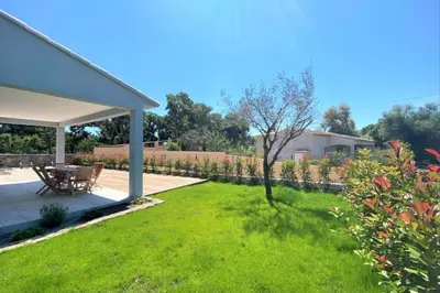 a garden with a picnic table and a lawn at Villa Oliu Di Santa Lucia in Conca