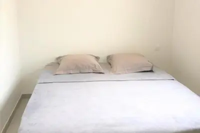 a bed in a room with two pillows on it at Villa Oliu Di Santa Lucia in Conca
