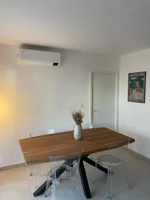 a dining room with a wooden table and chairs at Charming Apartment Ajaccio in Ajaccio