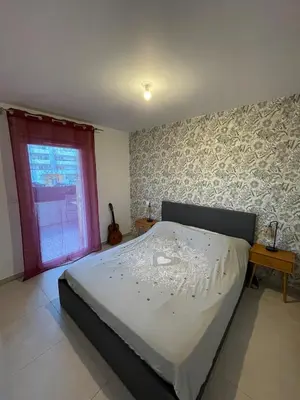 a large bed in a bedroom with a window at Charming Apartment Ajaccio in Ajaccio