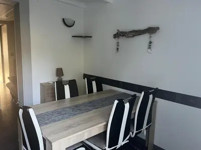 a dining room table with chairs and a wooden table at Maisonnette privé bord de mer Poggio mezzana in Poggio-Mezzana