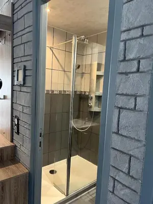 a glass door of a shower in a bathroom at Maisonnette privé bord de mer Poggio mezzana in Poggio-Mezzana