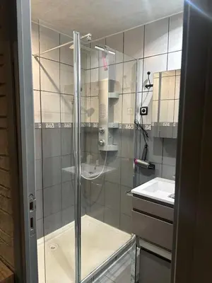a glass shower in a bathroom with a sink at Maisonnette privé bord de mer Poggio mezzana in Poggio-Mezzana