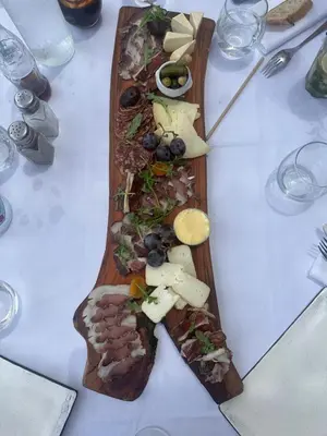 a wooden plate of food on a table at Maisonnette privé bord de mer Poggio mezzana in Poggio-Mezzana