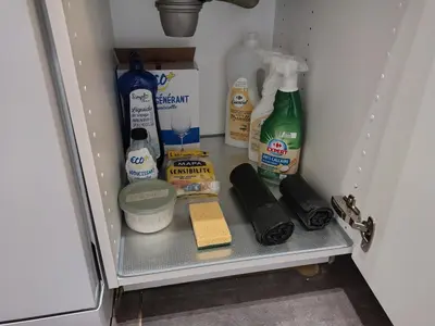a refrigerator filled with bottles of milk and other items at Résidence des îles - Samos III in Ajaccio
