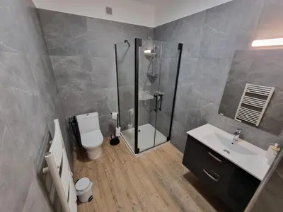 a bathroom with a shower and a toilet and a sink at Résidence des îles - Samos III in Ajaccio