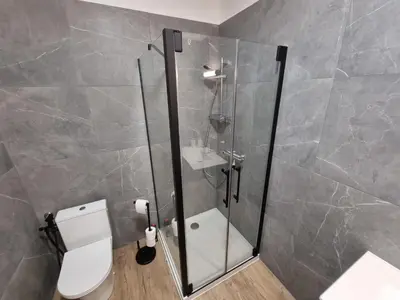 a bathroom with a shower with a toilet and a sink at Résidence des îles - Samos III in Ajaccio
