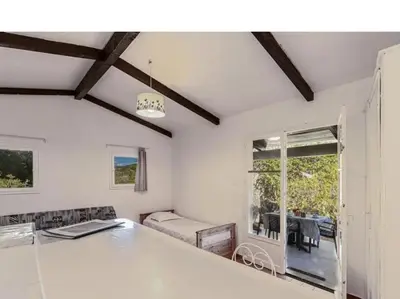 a living room with a table and a dining room at Villa Lavezzi F2 2-4 pers Rondinara, Bonifacio in Bonifacio