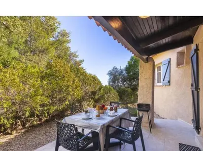 a table with chairs sitting on a patio at Villa Lavezzi F2 2-4 pers Rondinara, Bonifacio in Bonifacio