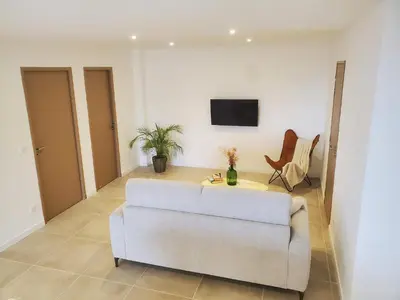 a living room with a couch and a tv at location Appartement Cargèse in Cargèse