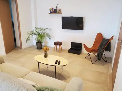 a living room with a couch and a table at location Appartement Cargèse in Cargèse