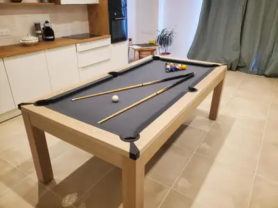 a pool table with cue sticks on it in a kitchen at location Appartement Cargèse in Cargèse