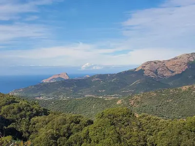 a view of mountains with the ocean in the background at location Appartement Cargèse in Cargèse