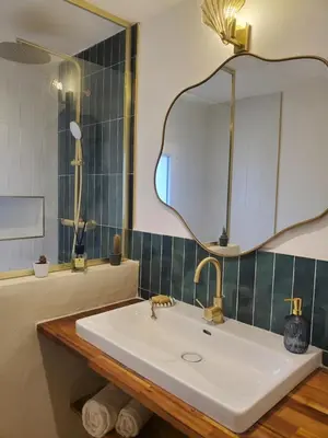 a bathroom with a sink and a mirror at location Appartement Cargèse in Cargèse