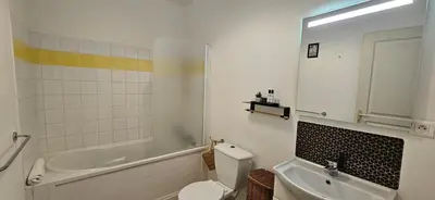 a bathroom with a toilet and a tub and a sink at T2 Alba Rossa n 124, Chaleureux vue mer et piscine in Serra-di-Ferro