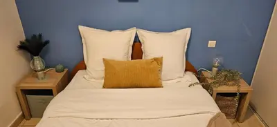 a bedroom with a bed with white sheets and pillows at T2 Alba Rossa n 124, Chaleureux vue mer et piscine in Serra-di-Ferro