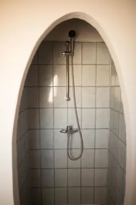 a shower in a bathroom with a tile wall at Villa RoccaPina 35 m2 - 2 - 4 people Rondinara, Bonifacio in Bonifacio