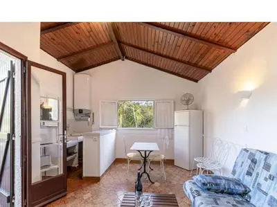 a living room with a couch and a table at Villa RoccaPina 35 m2 - 2 - 4 people Rondinara, Bonifacio in Bonifacio