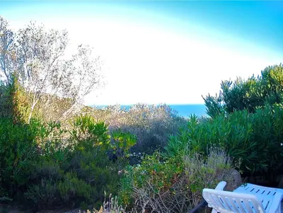 a white chair sitting on top of a hill at Villa 65m2 7 pers - Rondinara, Bonifacio in Bonifacio