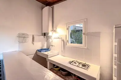a white bathroom with a sink and a window at Villa Balistra 45 m2 5 pers Rondinara Bonifacio in Bonifacio