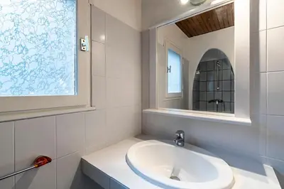 a white bathroom with a sink and a mirror at Villa Balistra 45 m2 5 pers Rondinara Bonifacio in Bonifacio