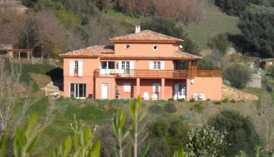 a house on the side of a hill at JARDIN de PRATAVONE in Cognocoli-Monticchi