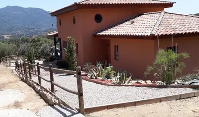 a house with a fence in front of it at JARDIN de PRATAVONE in Cognocoli-Monticchi