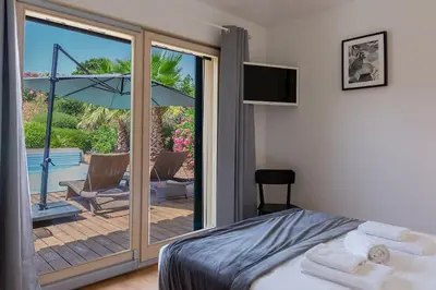 a bedroom with a bed and a sliding glass door at Les Hameaux De Buttaciolo in Cuo