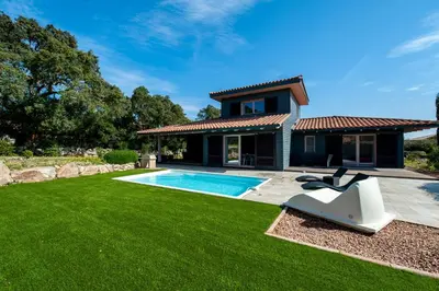 a house with a swimming pool and a lawn at Les Hameaux De Buttaciolo in Cuo