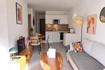 a living room with a couch and a table at Filori - T2 avec piscine chauffée et plage privée in Pianottoli-Caldarello