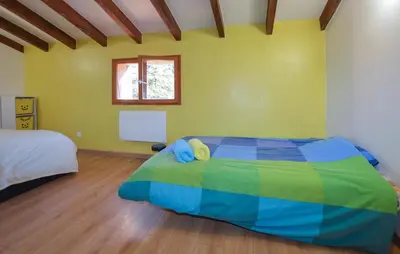 a bedroom with a colorful bed and a window at Grande Villa Piscine in Evisa