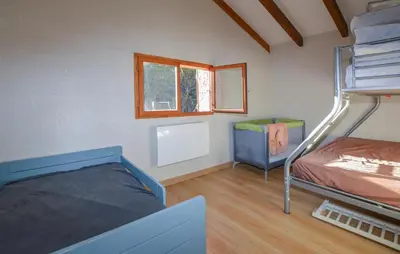 a bedroom with two bunk beds and a window at Grande Villa Piscine in Evisa