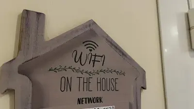 a sign on a wall with a sign on the house at La villa Emmagathe in Poggio-Mezzana