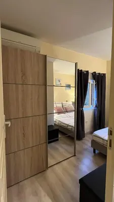 a mirror in a room with a bed and a bedroom at La villa Emmagathe in Poggio-Mezzana