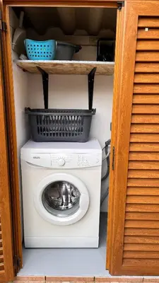 a washing machine with a basket on top of it at La villa Emmagathe in Poggio-Mezzana
