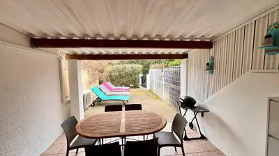 a patio with a table and chairs on a balcony at La villa Emmagathe in Poggio-Mezzana