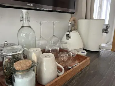 a counter top with glass bottles and jars on it at Casetta di Asciaghju, suite avec jacuzzi privé et accès direct aux plages in Porto-Vecchio