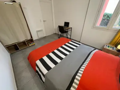 a bedroom with a bed and a desk in it at Mini Villa - Les Hameaux de Saint Cyprien in Lecci