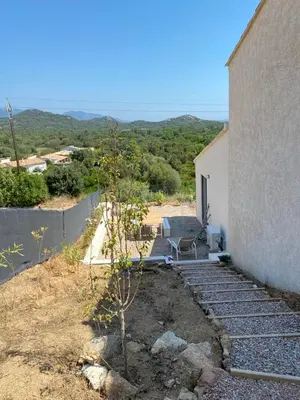 a small tree next to a building with a chair at Casa Gioia Maisonette à Sotta in Sotta