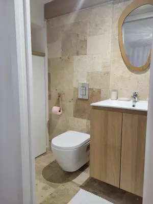a bathroom with a toilet and a sink and a mirror at Casa Gioia Maisonette à Sotta in Sotta