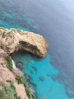 a cave in the side of a cliff at Port de Bonifacio in Bonifacio