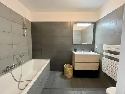 a bathroom with a bath tub and a sink at Port de Bonifacio in Bonifacio